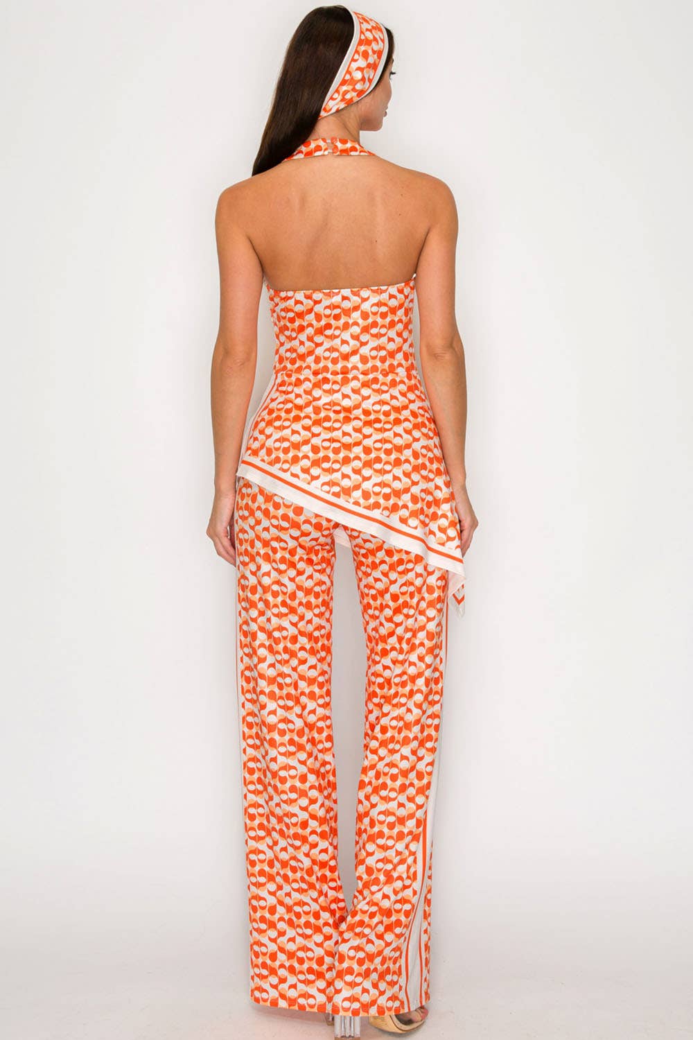 Back view orange halter printed jumpsuit from She Rare Boutique